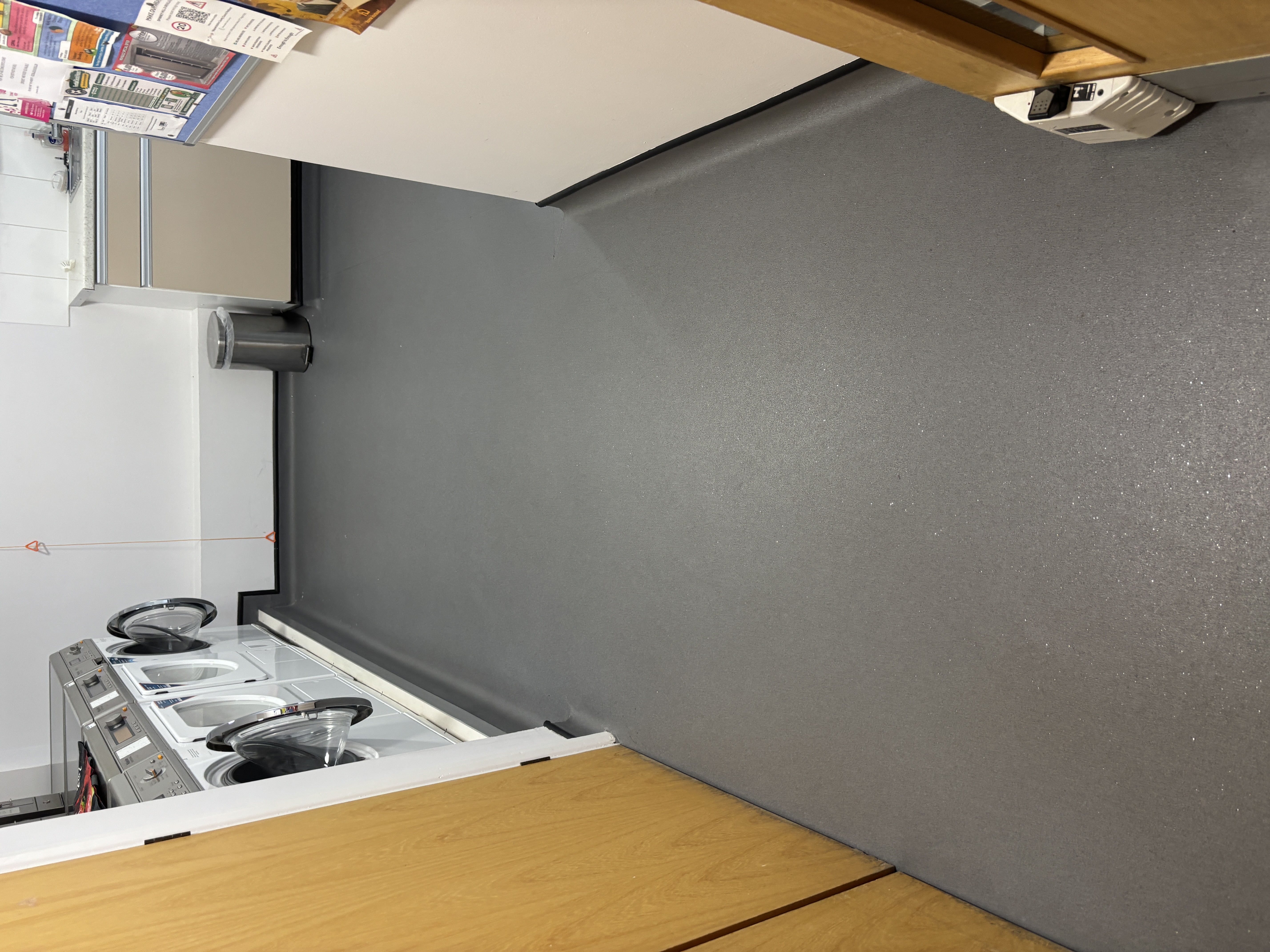 Non-Slip Flooring in a Laundry Room Grey non-slip safety flooring in a laundry room with commercial washing machines